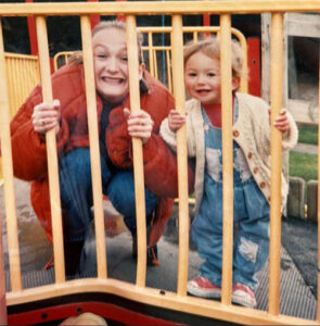 Sarah and Holly with Holly as a child at the playground.