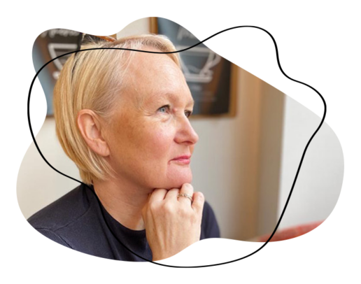 Sarah with her hand on her chin looking thoughtful.