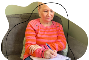Sarah sat down writing on a notepad.