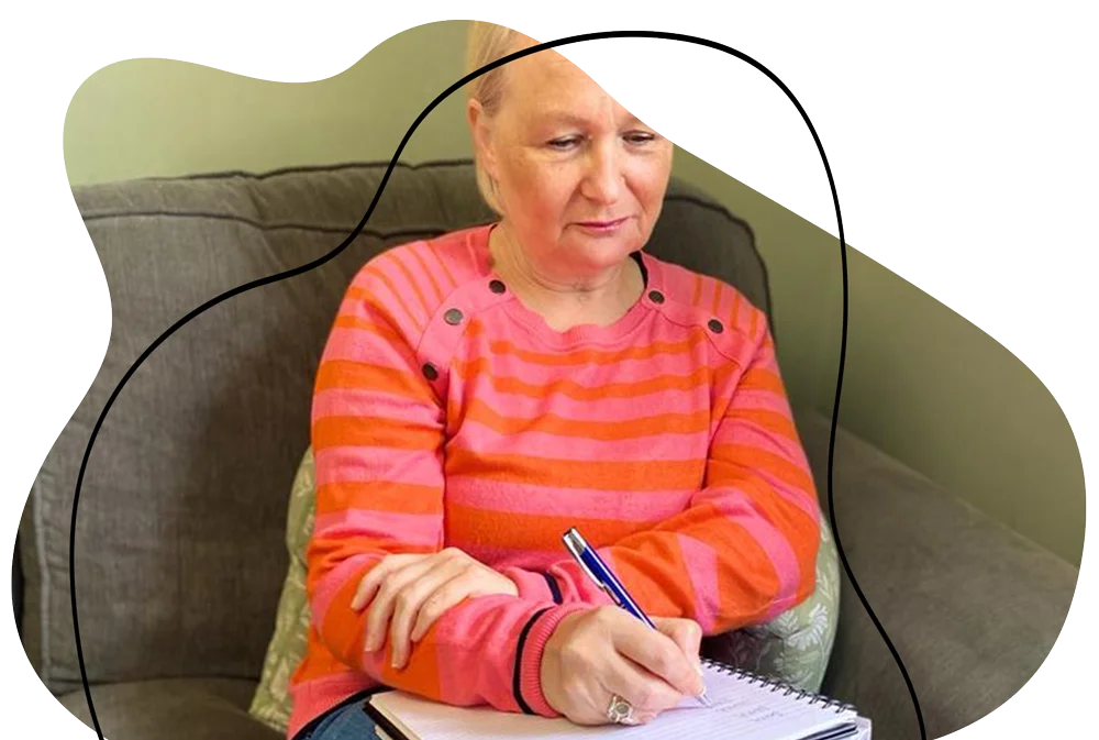 Sarah sat down writing on a notepad.